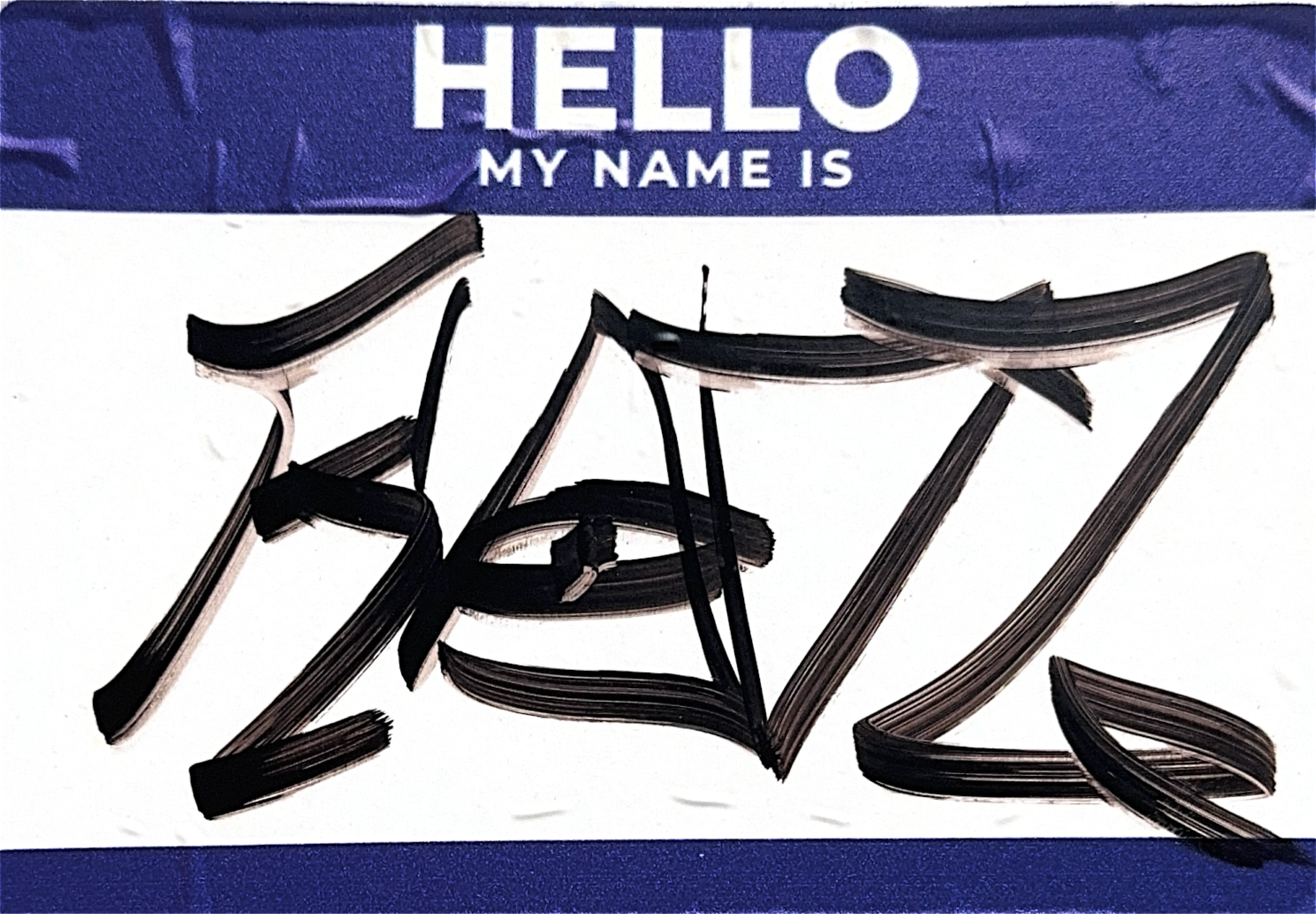 A Hello, my name is name tag sticker, navy header and footer around a white name field scrawled over with a black signature.